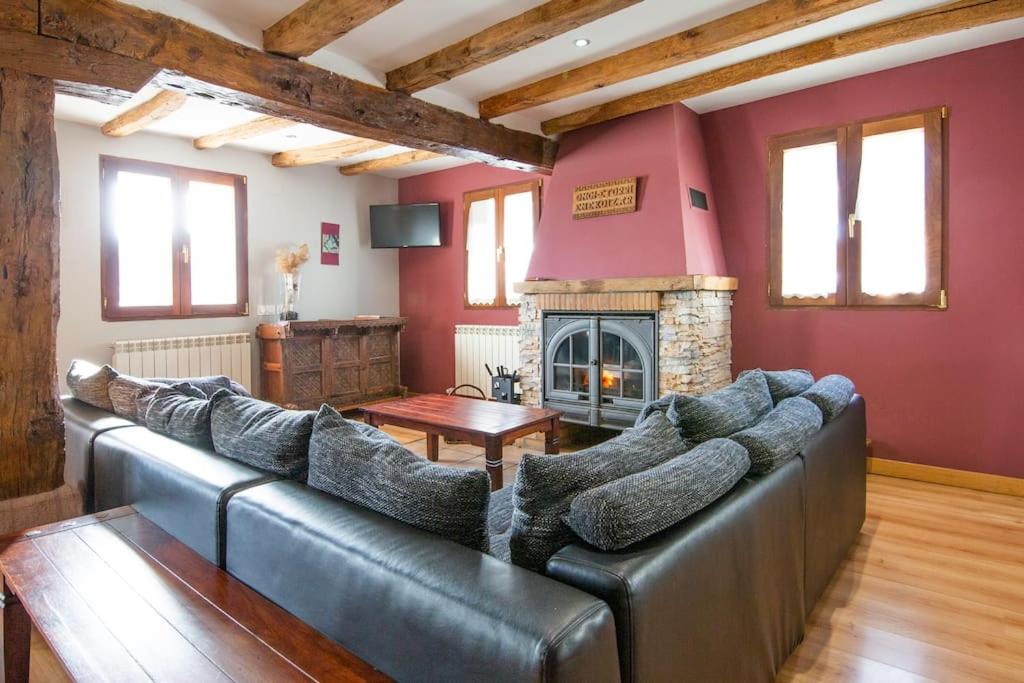 a living room with a couch and a fireplace at Casa rural Enekoizar in Abaurrea Alta