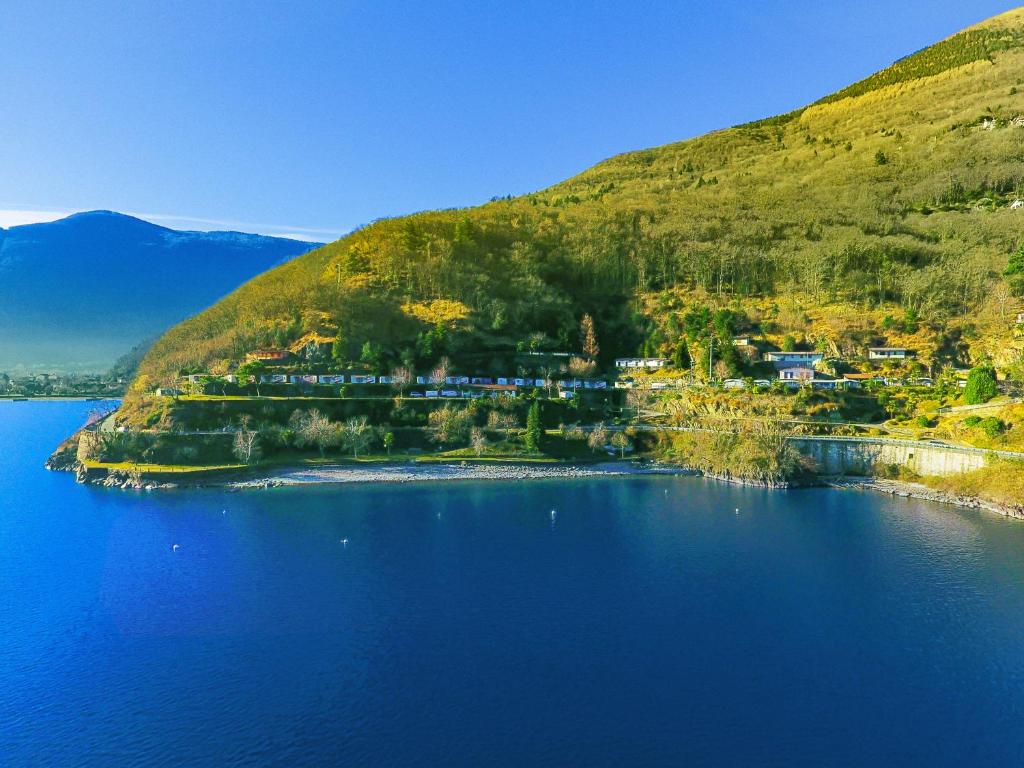 an island in the middle of a body of water at Lakeview Cannobio Camping & Resort in Cannobio