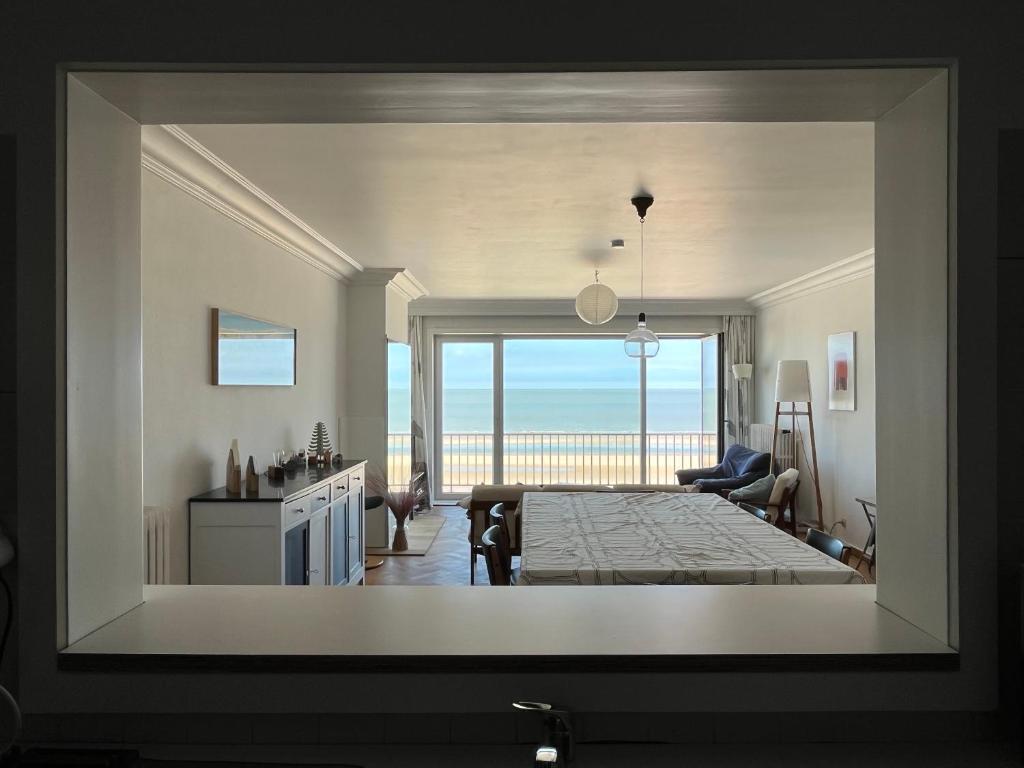 a view of a living room with a view of a bedroom at oase at the sea in De Haan