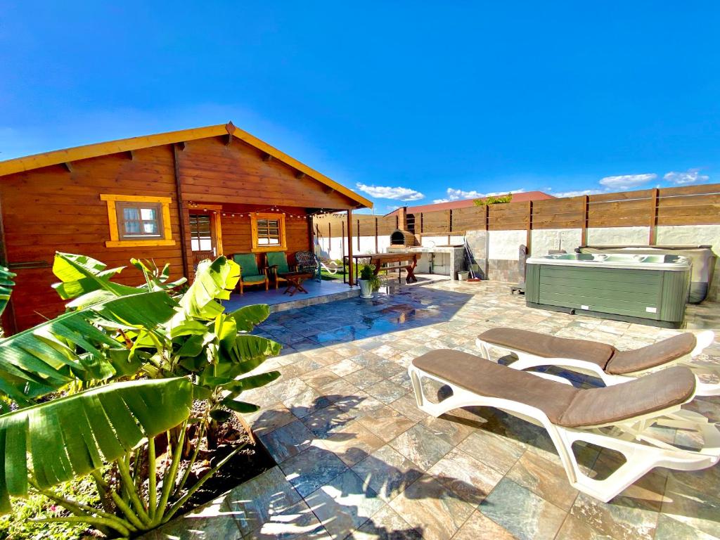 a patio with two chairs and a house at Canary Wild House 2 in Carrizal