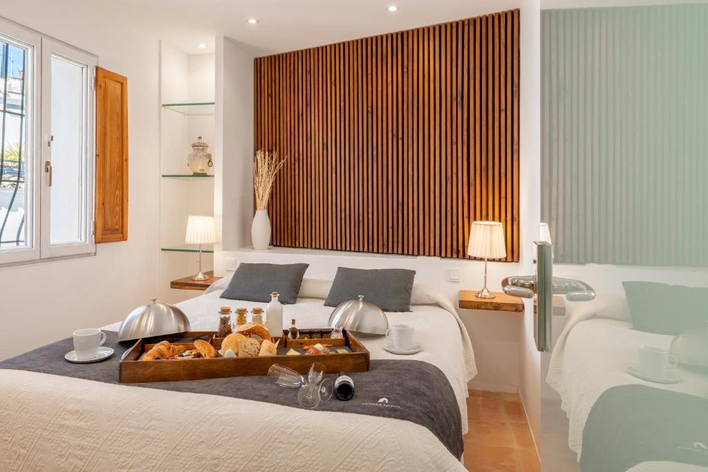 a bedroom with two beds with a tray of food on it at Porta Nova Suites - Room Breakfast & Sea View in Altea