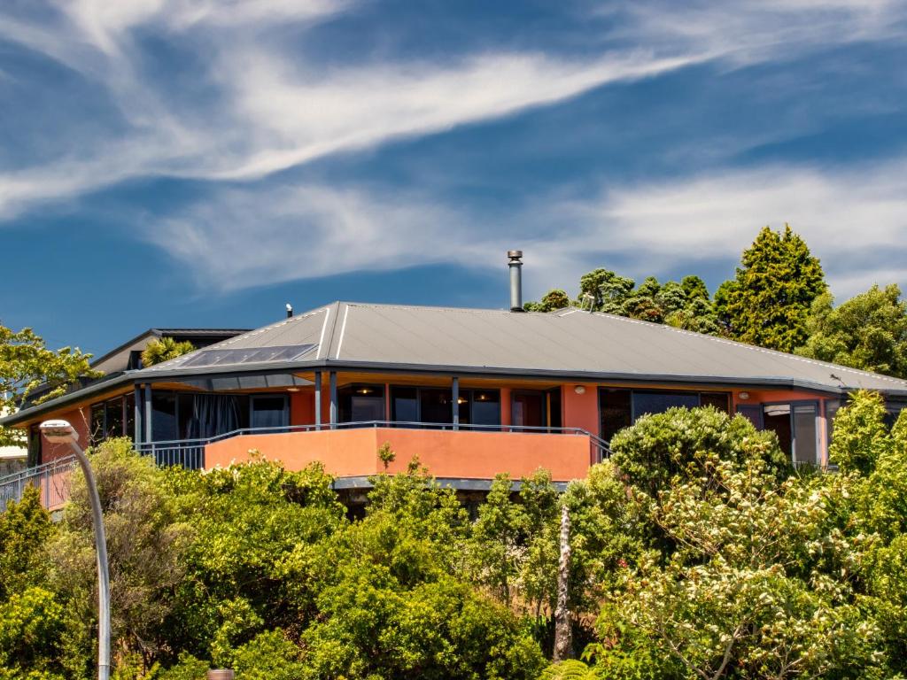 a building with a roof on top of trees at Aorere House - Collingwood Holiday Home in Collingwood