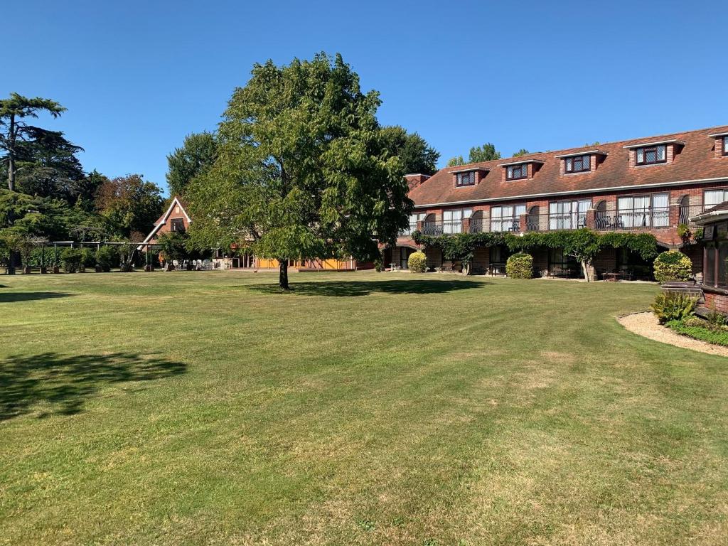 a large grass field in front of a building at Springfield Country Hotel, Leisure Club & Spa in Wareham