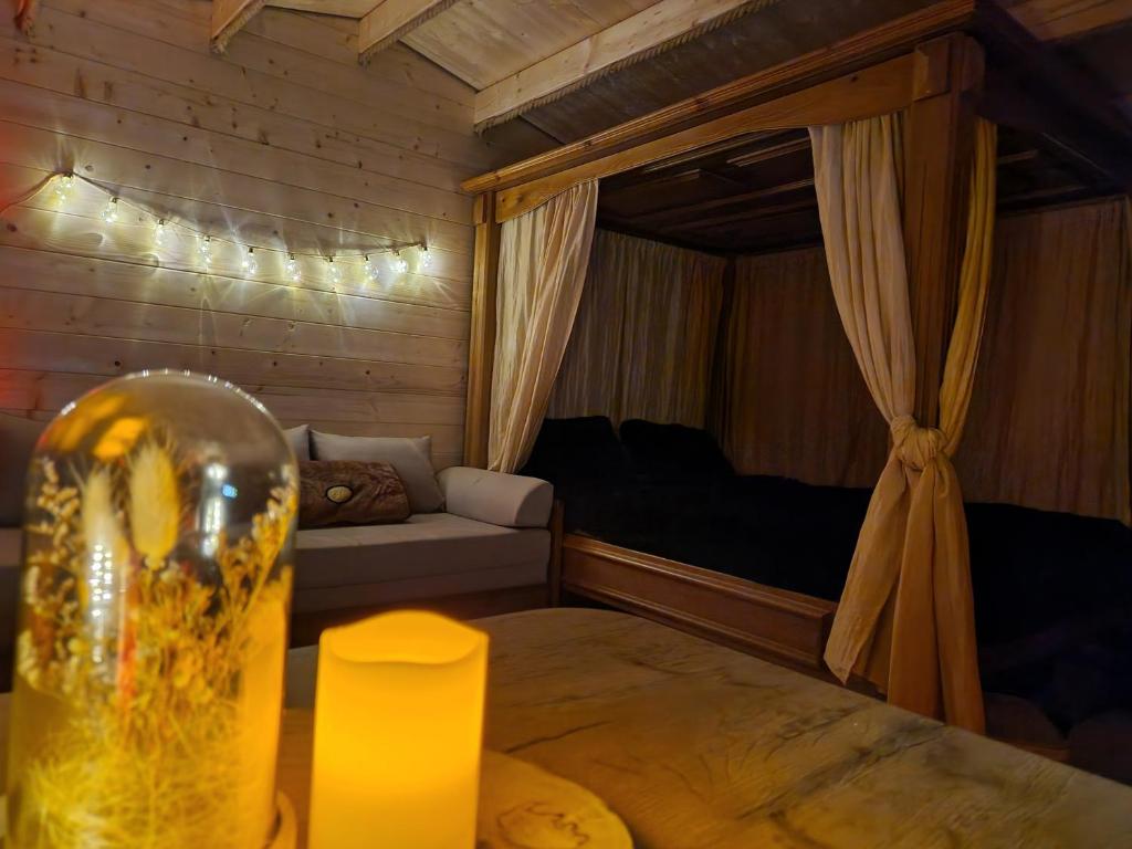 um pequeno quarto com uma cama e um sofá em Treehouse Podpoľanie em Detvianska Huta