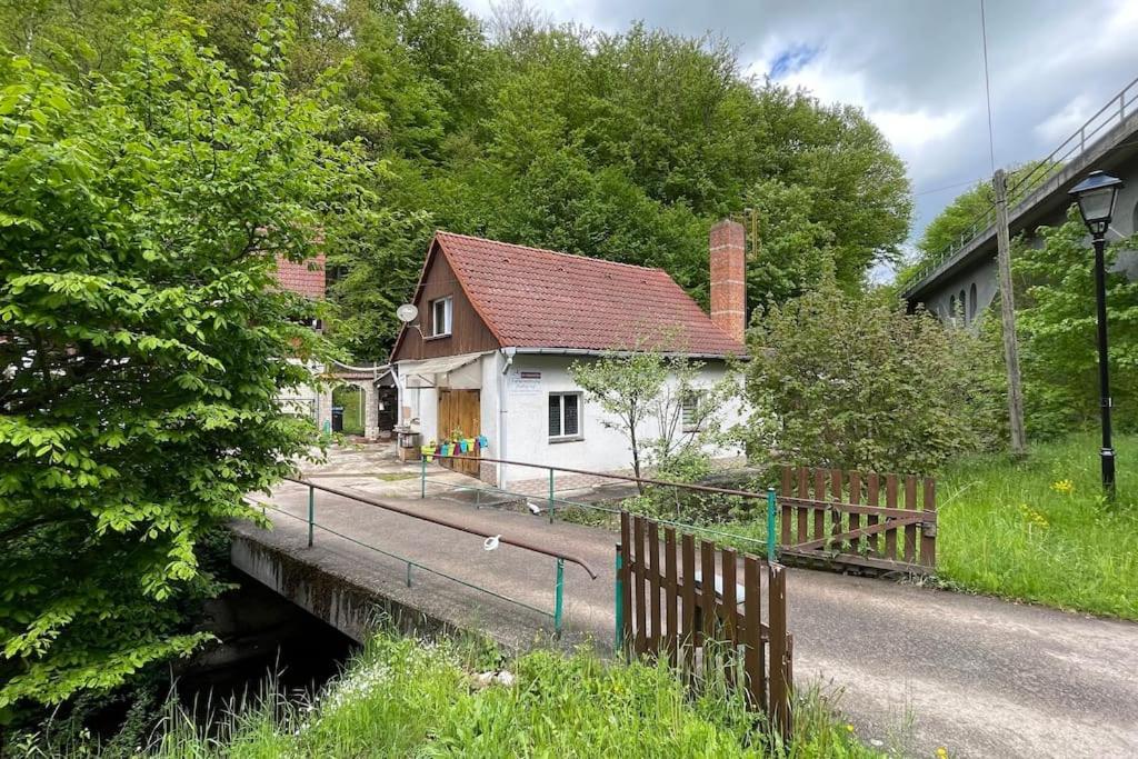 a house on the side of a road next to a bridge at Ferienwohnung Katharina in Stolberg (Harz) in Stolberg