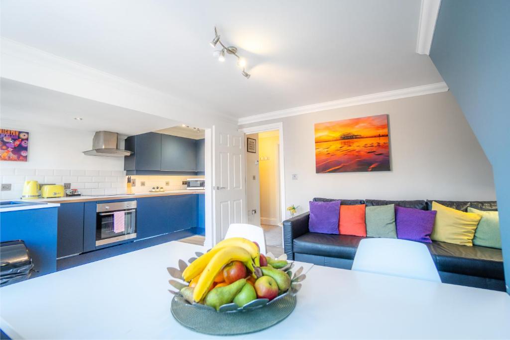 een keuken en een woonkamer met een fruitschaal op een tafel bij Brunswick Fab Pad - By My Getaways in Brighton & Hove