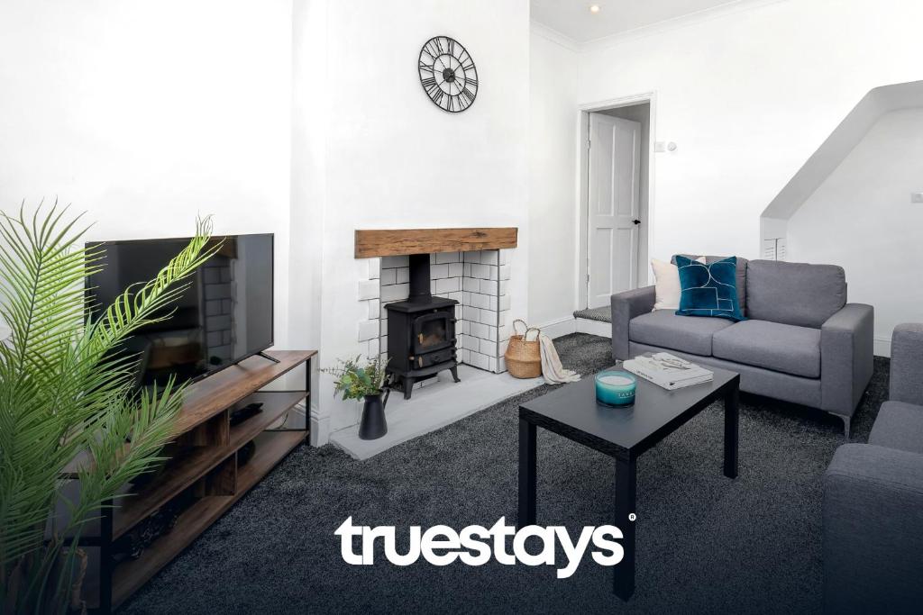 a living room with a couch and a fireplace at Chorlton House by Truestays - NEW 2 Bedroom House in Stoke-on-Trent in Hanley