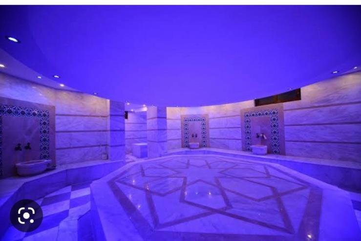 een grote kamer met paarse verlichting en een grote verdieping bij Ottoman village in Okurcalar