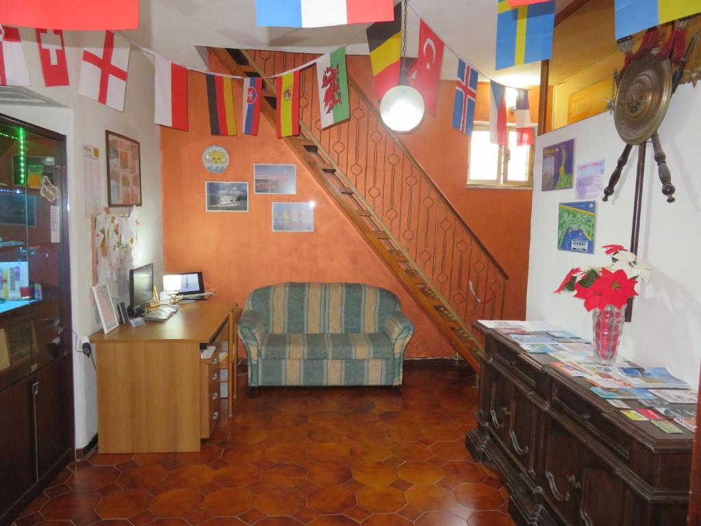 a room with a staircase with a chair and a desk at Casa Vacanze Sole & Luna in Milazzo