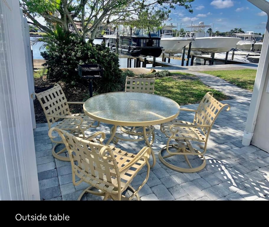 a glass table and chairs sitting on a patio at Cheerful home with one bedroom in Cape Coral