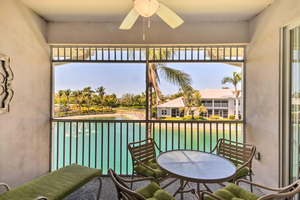 a balcony with a table and chairs and a large window at Beautiful Naples Golf Villa in Famous Lely Resort! in Naples