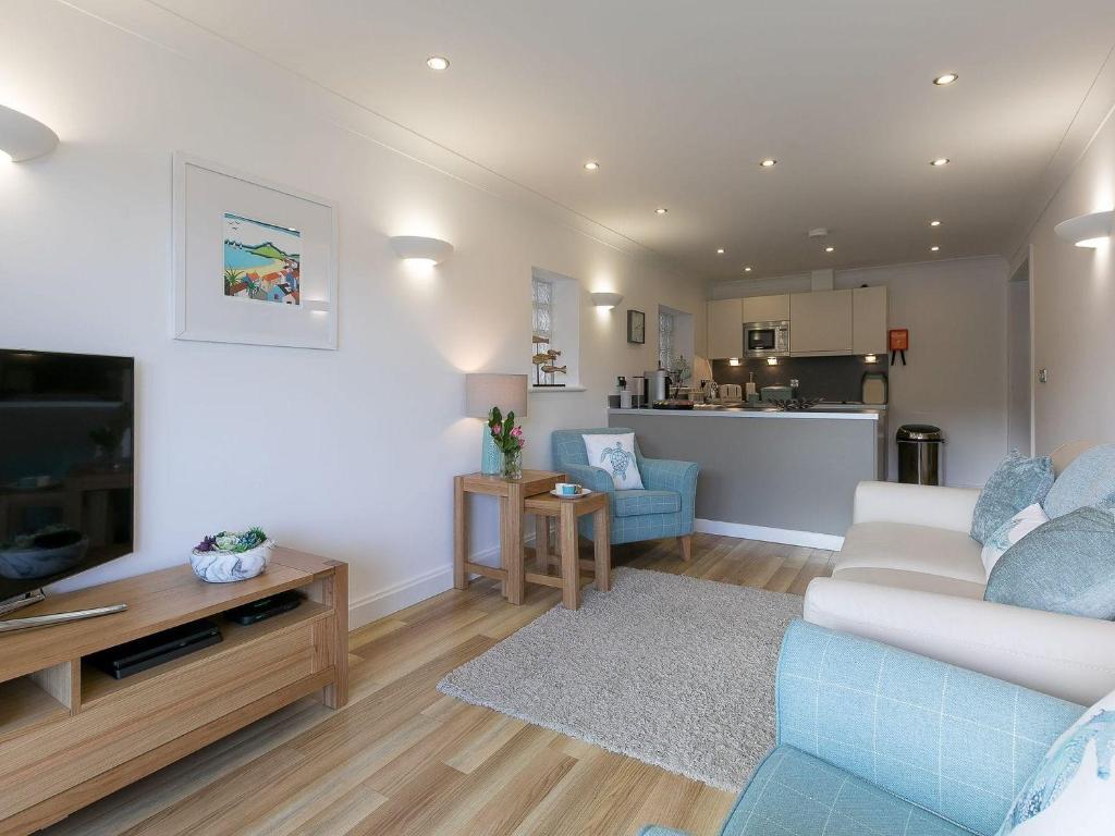a living room with a couch and a tv at Atlantis in St Ives