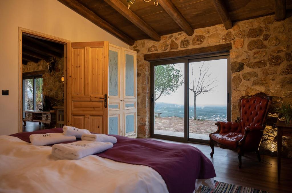 a bedroom with a large bed and a large window at Silo Stone House 