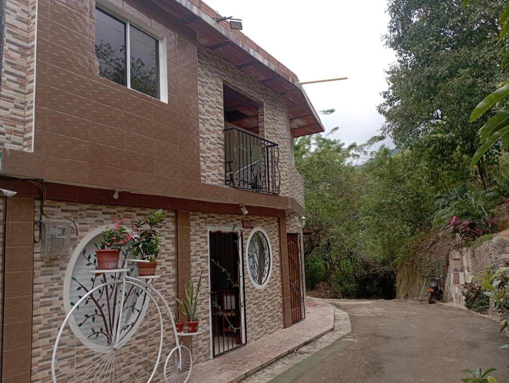 a brick house with a window and a balcony at Selva Maria Tayrona's Hostel in Santa Marta