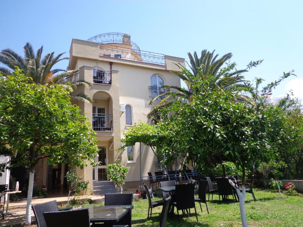 a building with tables and chairs in front of it at Villa Semashko in Bar