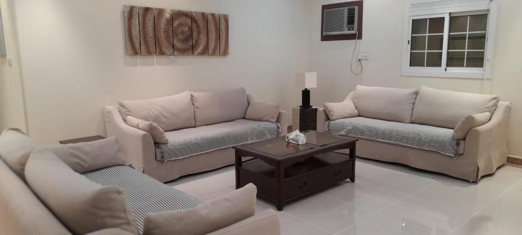 a living room with two couches and a coffee table at شقه مفروشه للايجار اليومي in Makkah