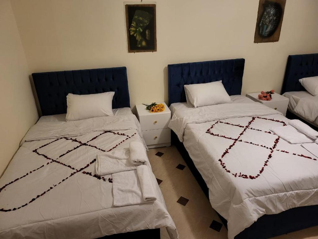 two beds sitting next to each other in a room at Lucky Pyramids View in Cairo