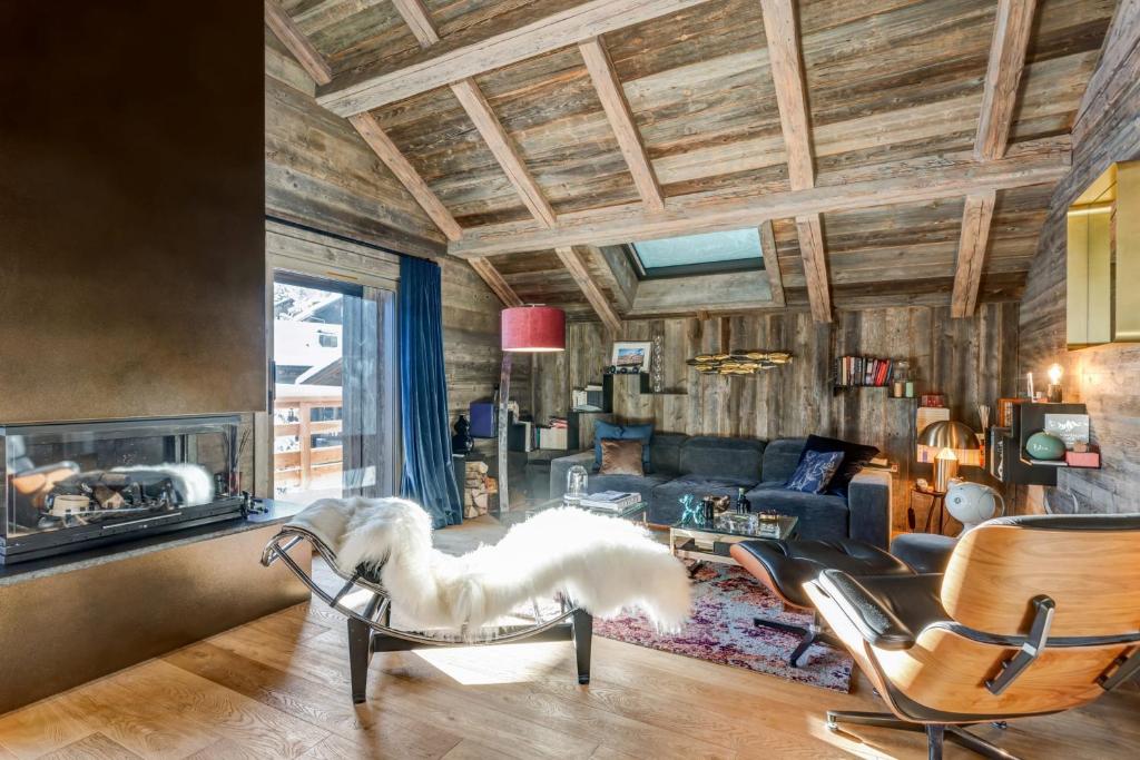 a living room with a couch and chairs at Luxury flat 2 steps to the cable cars in Megève - Welkeys in Megève