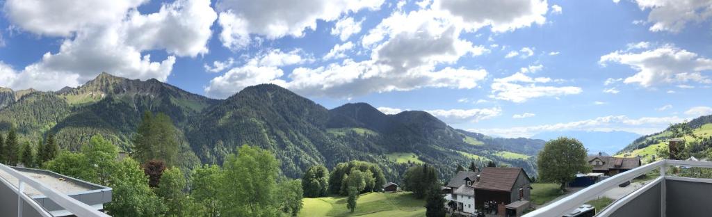 a view of a valley with mountains and a house at Walli Laterns in Laterns