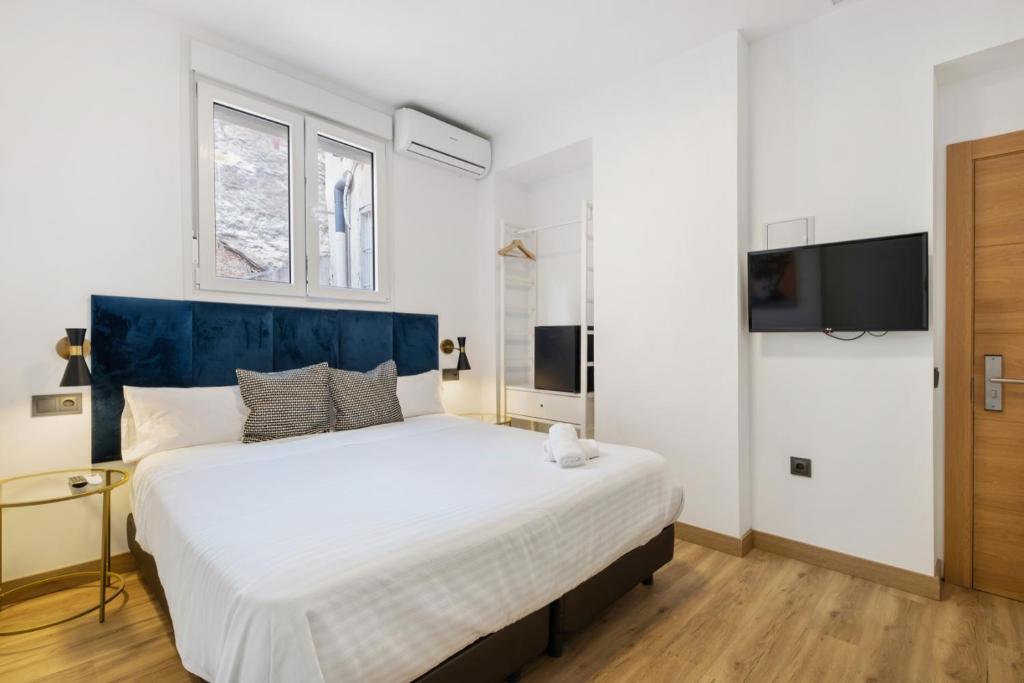 Posteľ alebo postele v izbe v ubytovaní Malaga City Suites
