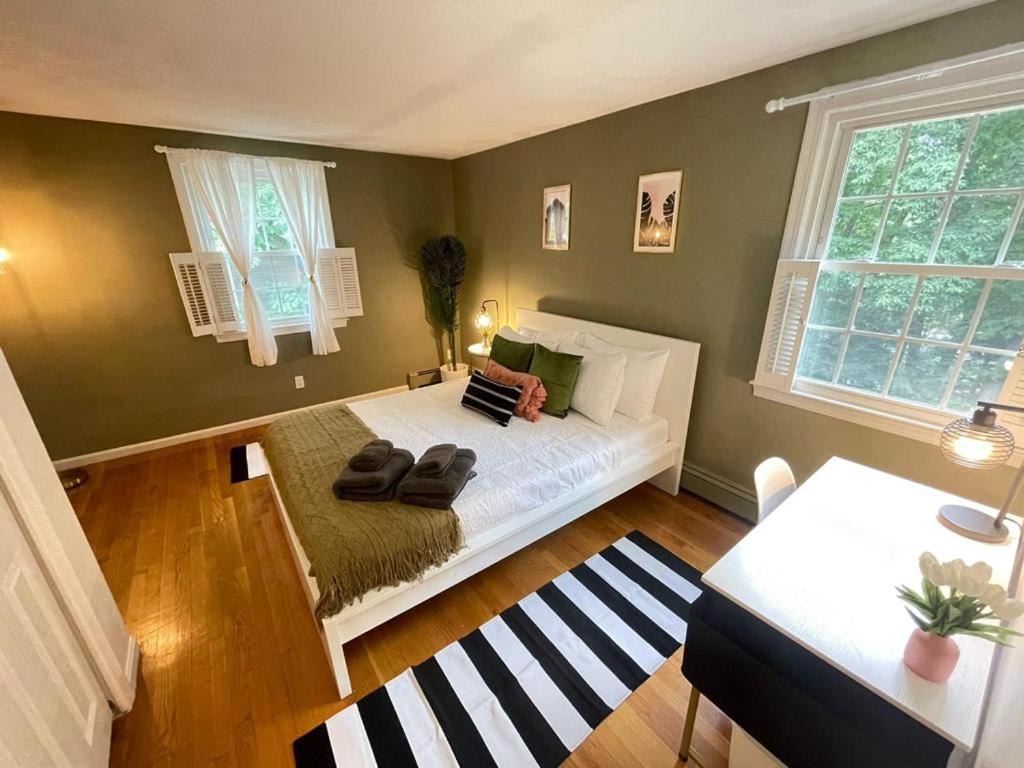 a bedroom with a bed and two windows at #17 ROOM IN THE HOUSE Peerless Design Room with Private Bathroom! in Waltham