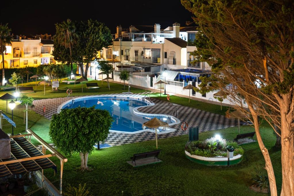 een afbeelding van een villa met een zwembad in de nacht bij Dúplex La Perla de Andalucia in Calahonda