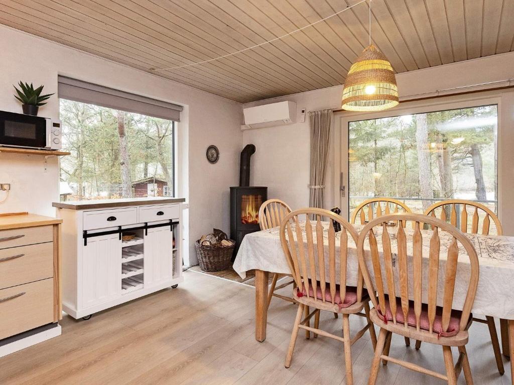 a kitchen and dining room with a table and chairs at Holiday home Blåvand CCCXV in Blåvand