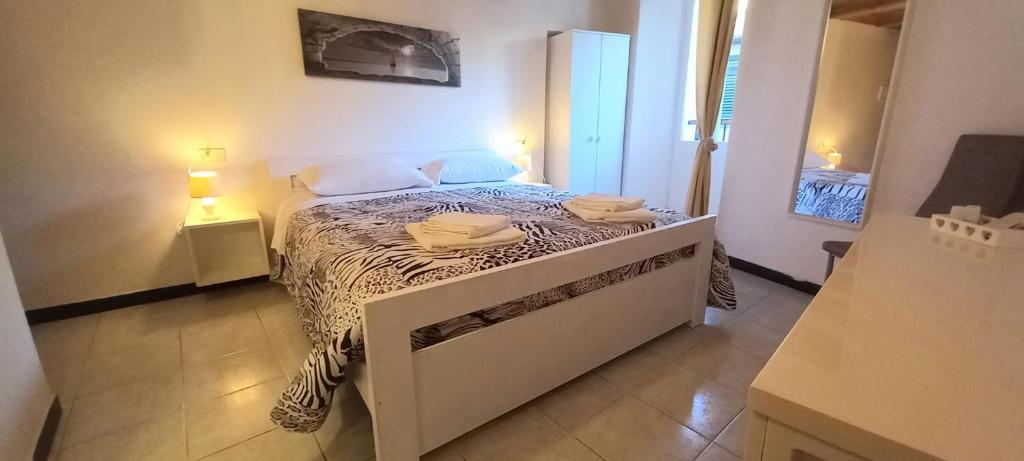 a small bedroom with a bed with towels on it at Chiara rooms in Vernazza