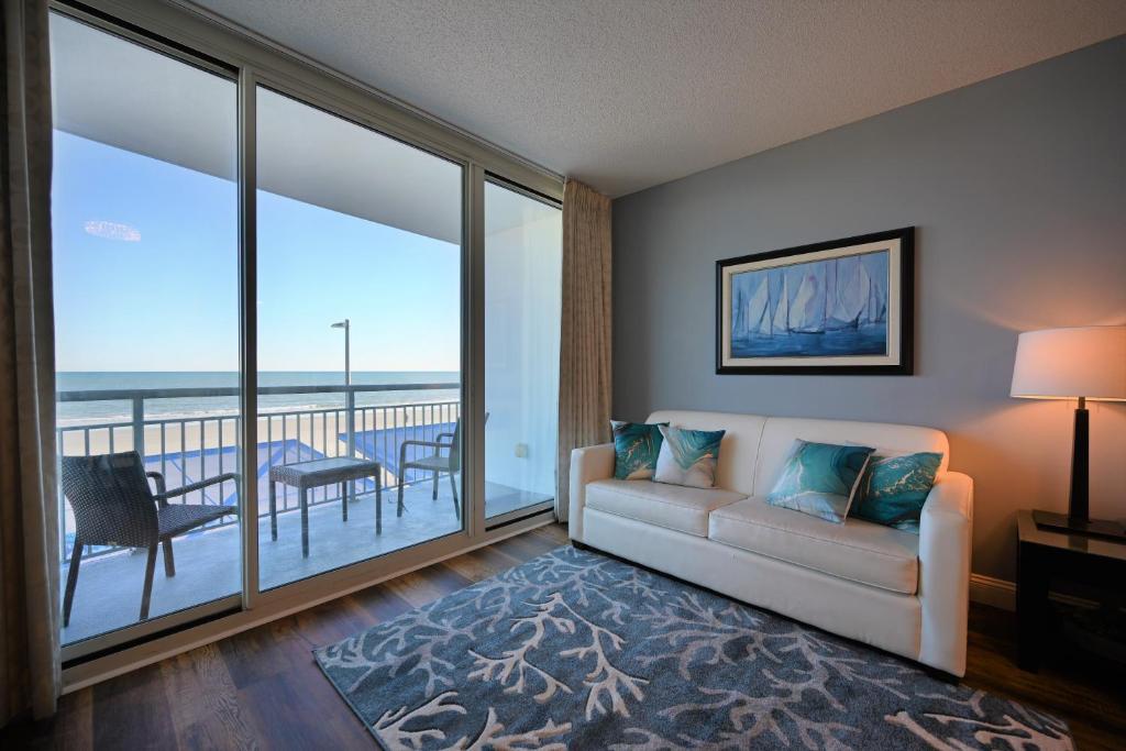 a living room with a couch and a view of the ocean at Spectacular Ocean Front Real 1 Bedroom Condo, 2 Ba in Myrtle Beach