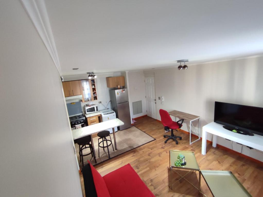 a room with a living room and a kitchen at departamento finas terminaciones en balneario in Puerto Montt