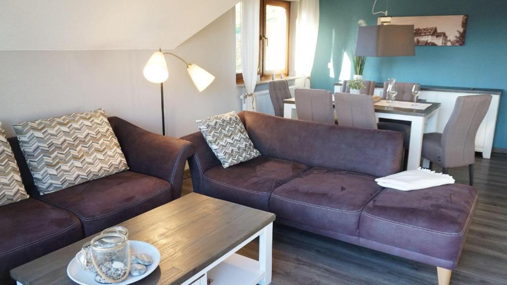 a living room with two couches and a table at Ferienwohnung Am Roten Turm in Meersburg