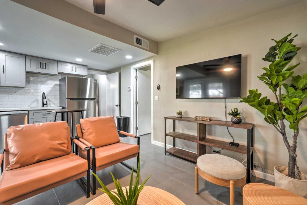 a living room with two chairs and a kitchen at Pet-Friendly Phoenix Vacation Rental with Yard in Phoenix