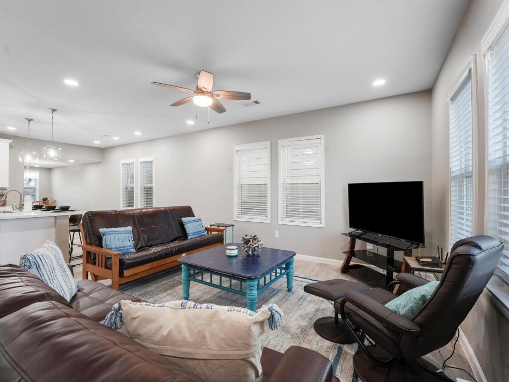 un soggiorno con divano e TV a schermo piatto di Galveston Escapes - Walk to Beach and Restaurants a Galveston