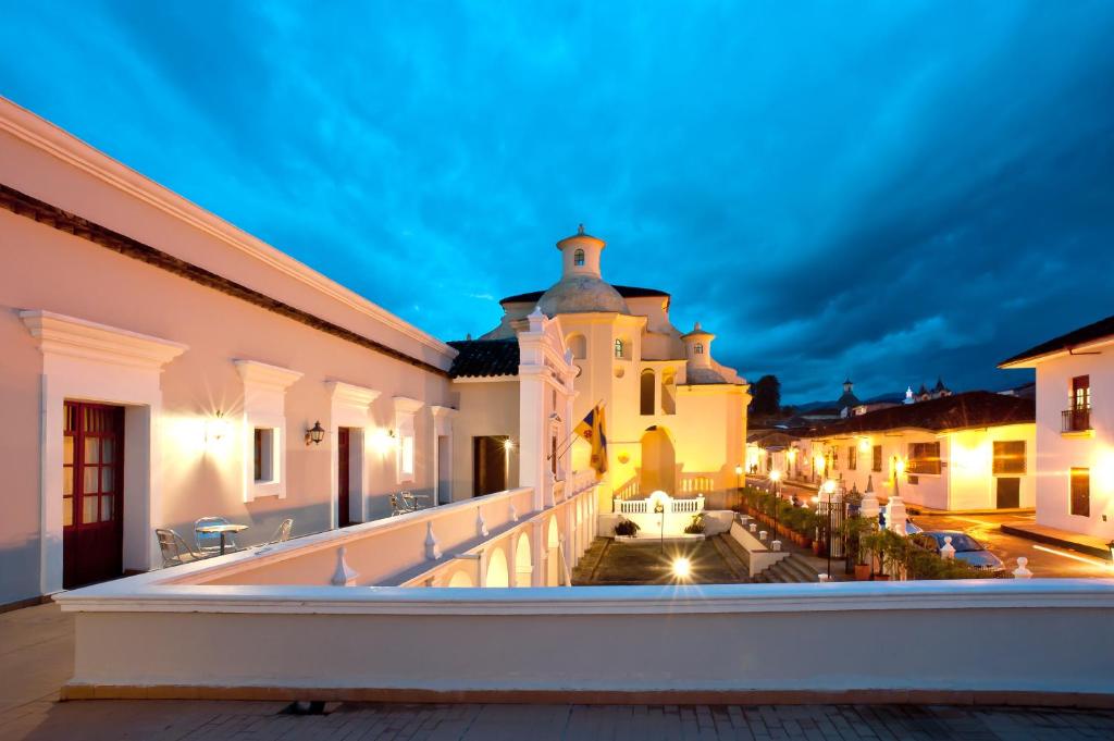 a view from the balcony of a building at night at Hotel Dann Monasterio in Popayan
