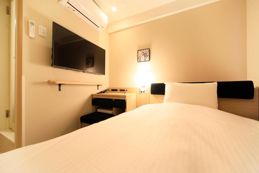 Postel nebo postele na pokoji v ubytování Hotel Nihonbashi Saibo