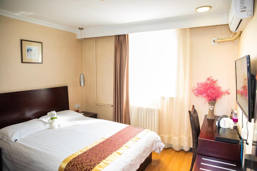 Postel nebo postele na pokoji v ubytování Meiyuan Hotel