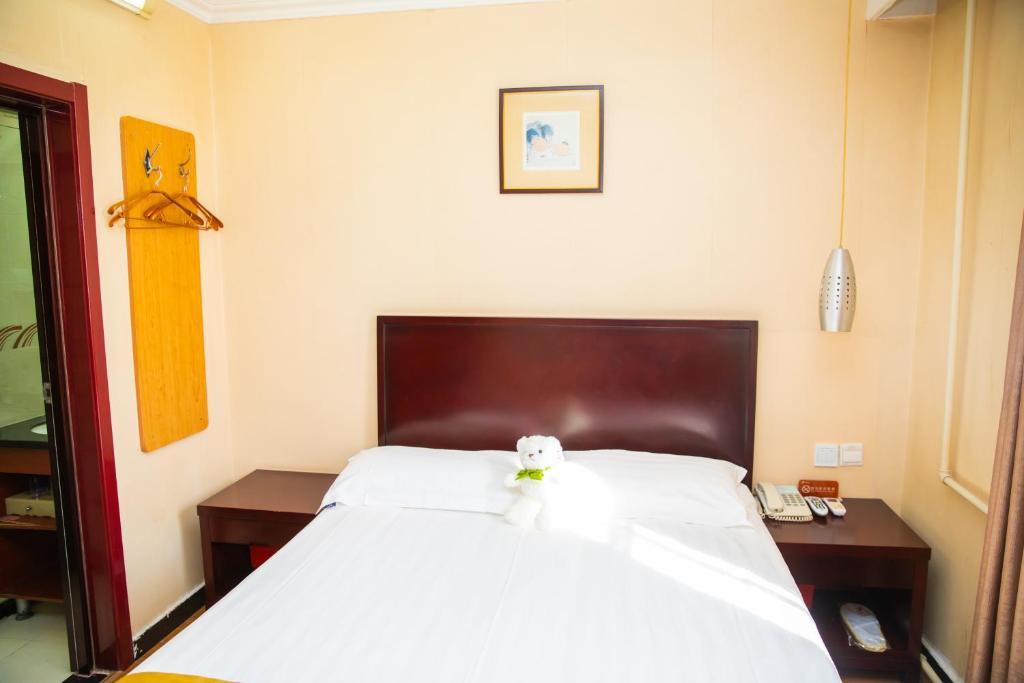 Postel nebo postele na pokoji v ubytování Meiyuan Hotel