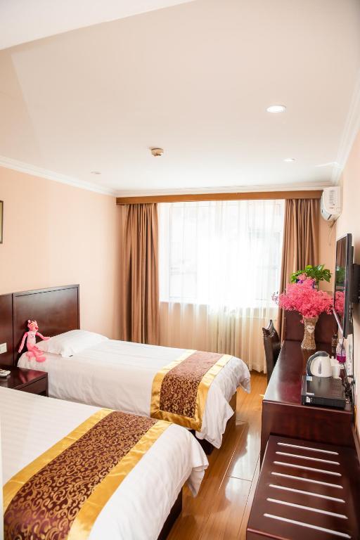 Postel nebo postele na pokoji v ubytování Meiyuan Hotel