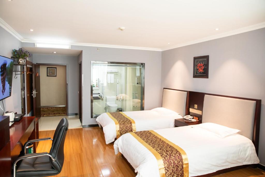 Postel nebo postele na pokoji v ubytování Meiyuan Hotel
