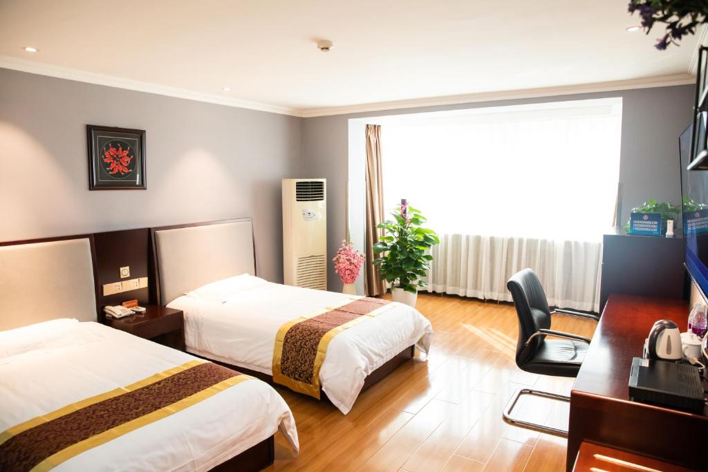 Postel nebo postele na pokoji v ubytování Meiyuan Hotel