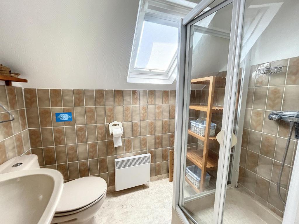 a bathroom with a toilet and a glass shower at Maison Saint-Pair-sur-Mer, 5 pièces, 8 personnes - FR-1-361-56 in Saint-Pair-sur-Mer
