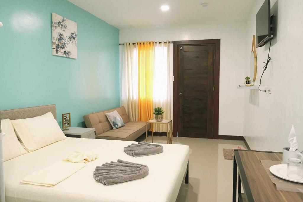 ein Schlafzimmer mit einem Bett mit Handtüchern darauf in der Unterkunft Casa D’ Hiyas Homestay Panglao, Bohol in Panglao