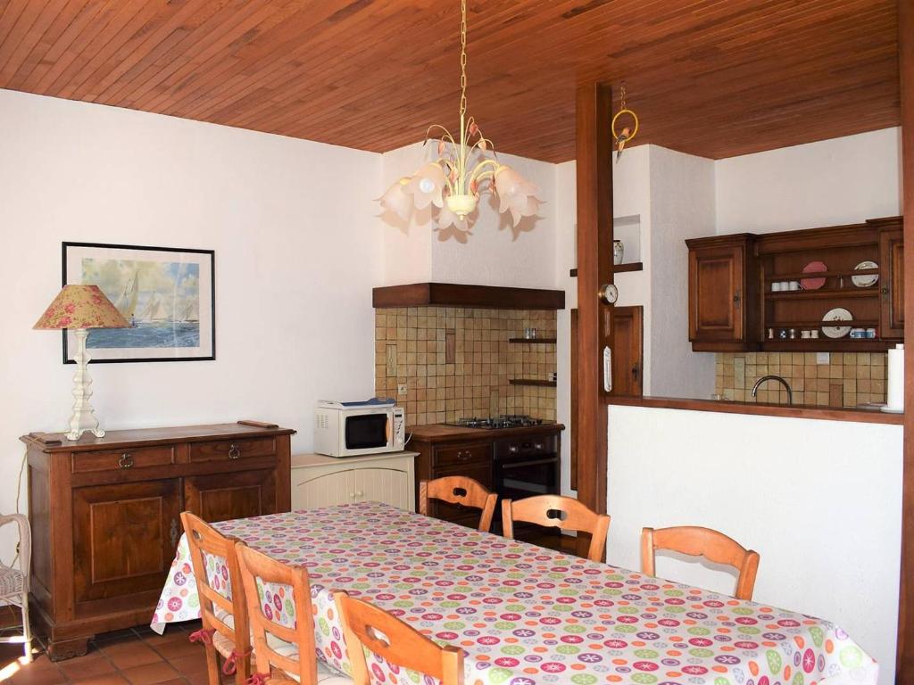a kitchen with a dining room table and a table and chairs at Maison Trégastel, 4 pièces, 6 personnes - FR-1-368-106 in Trégastel