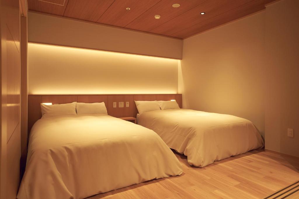 Postel nebo postele na pokoji v ubytování Sansuiso Tsuchiyu Spa