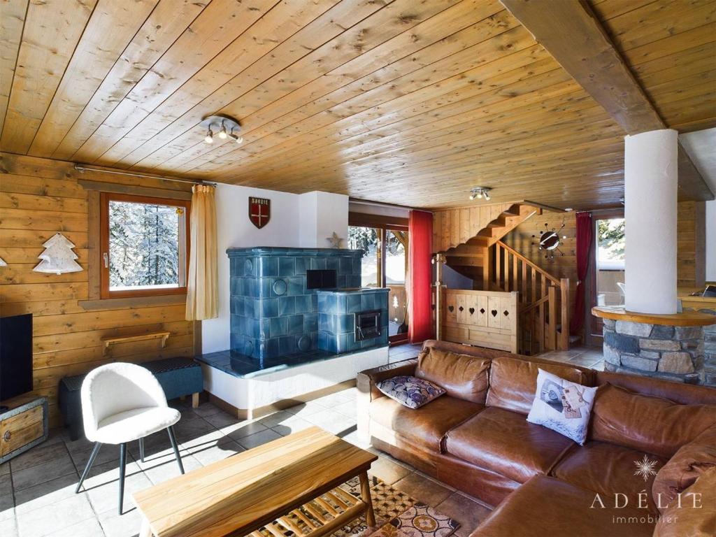 a living room with a couch and a fireplace at Appartement Montvalezan-La Rosière, 6 pièces, 11 personnes - FR-1-398-655 in Montvalezan