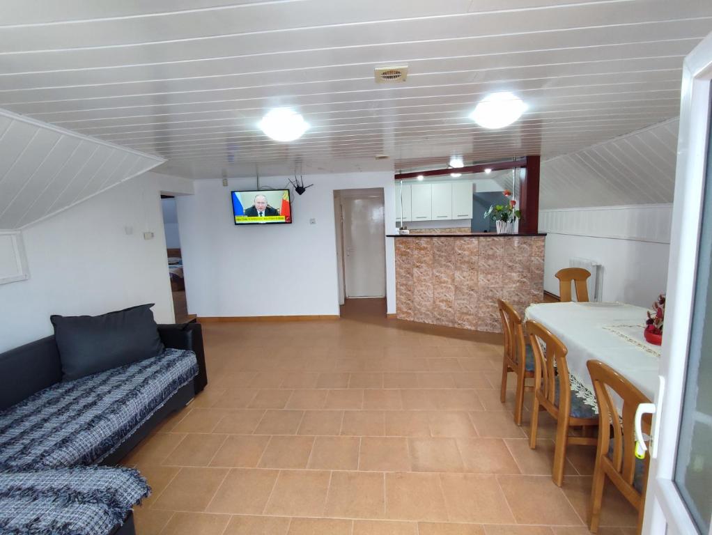 a living room with a couch and a table at Casa Daiana - Toplița in Topliţa
