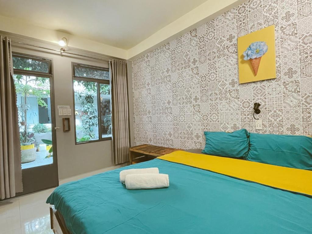 Postel nebo postele na pokoji v ubytování Da Lat Lemongrass - Đà Lạt Sả