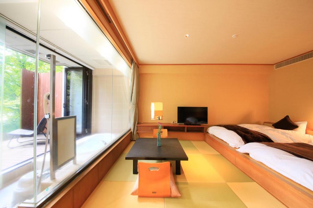 Postel nebo postele na pokoji v ubytování Hotel Shikisai