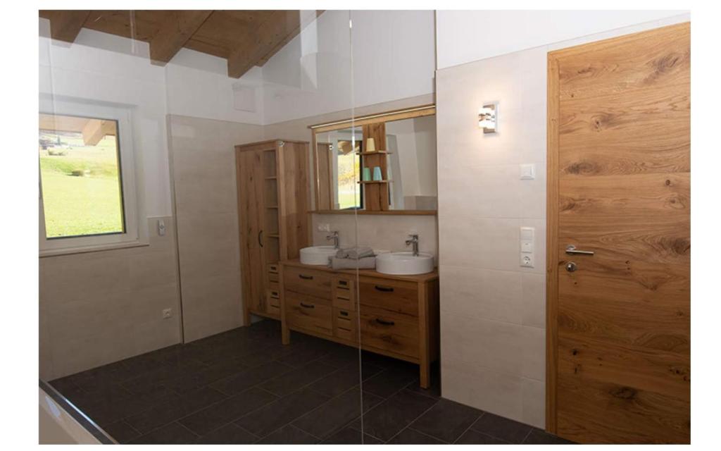 a bathroom with a sink and a mirror at Ferienhaus Reiter Jochberg bei Kitzbühel in Jochberg