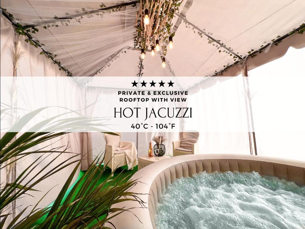 a hot tub in a tent with a chandelier at Colosseum Exclusive Apartment - Private Rooftop with Hot Tub and Stunning View in Rome